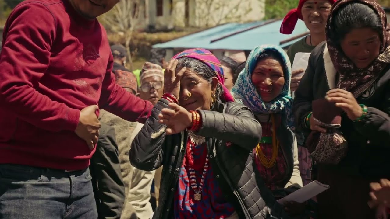A woman reacts with joy after receiving care